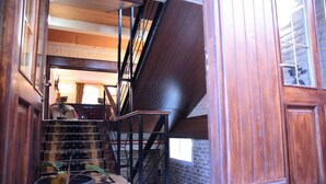 A staircase with a wooden finish, leading to an upper level. - Star Hotel Tashkent (Tashkent)