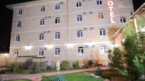 A multi-story hotel with a reception area, brick facade, and well-maintained garden. - Star Hotel Tashkent (Tashkent)