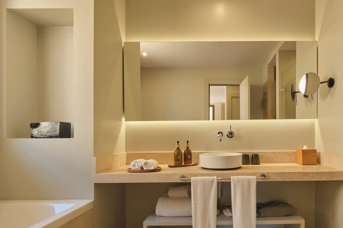 junior suite, 1 king bed | bathroom | designer toiletries, hair dryer, bathrobes, slippers