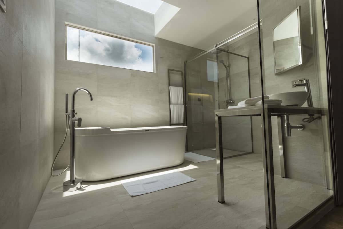 premium room, 1 queen bed, bathtub | bathroom | shower, free toiletries, hair dryer, towels