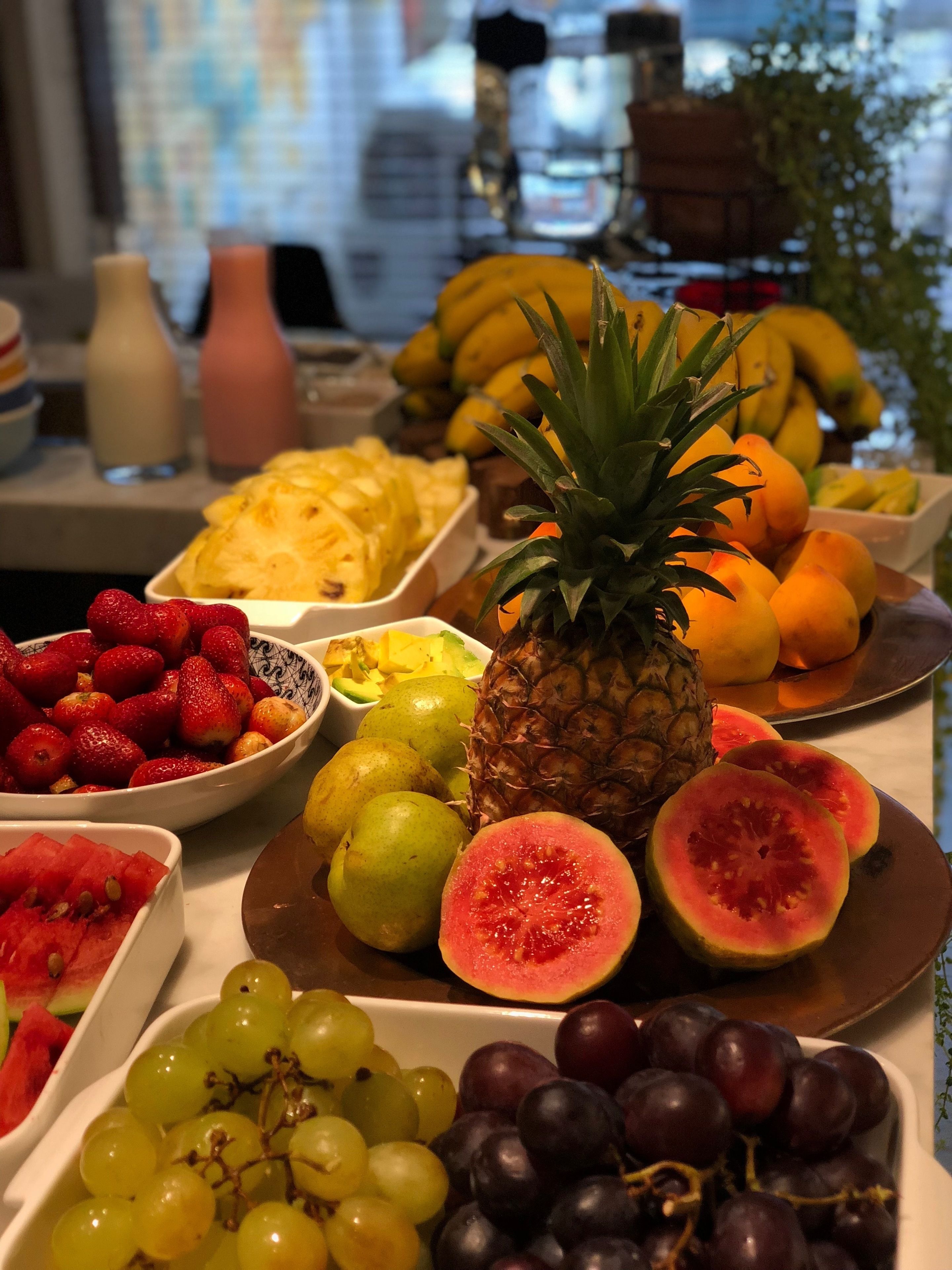A fruit platter with various fruits including grapes, strawberries, and watermelon.