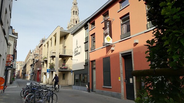 A street with a row of buildings, including a hostel with a sign. - Leuven City Hostel (Leuven)
