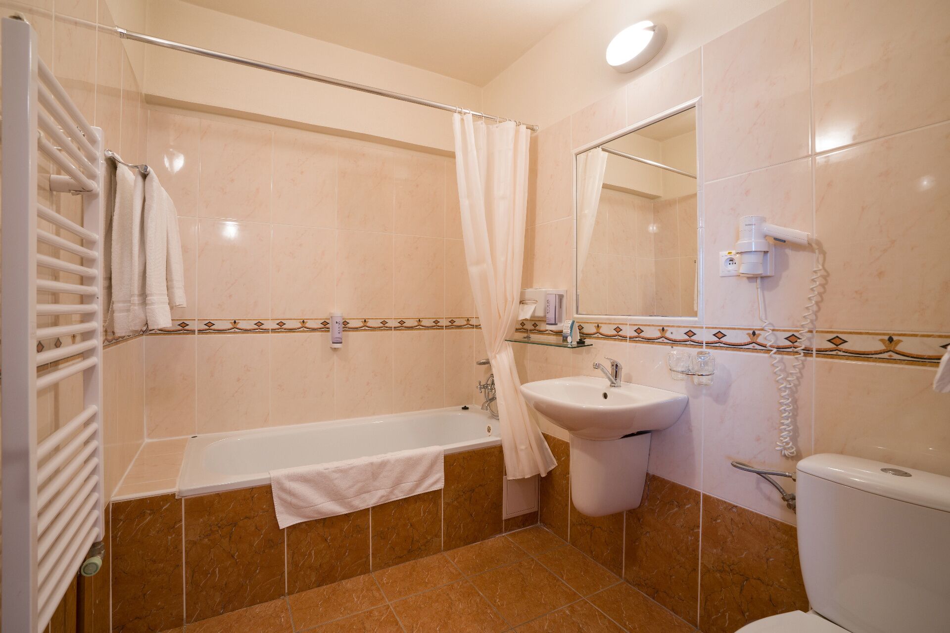 A bathroom with a bathtub, sink, and toilet.