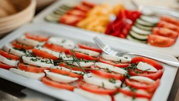 A plate of Caprese salad with tomatoes, mozzarella, and basil.