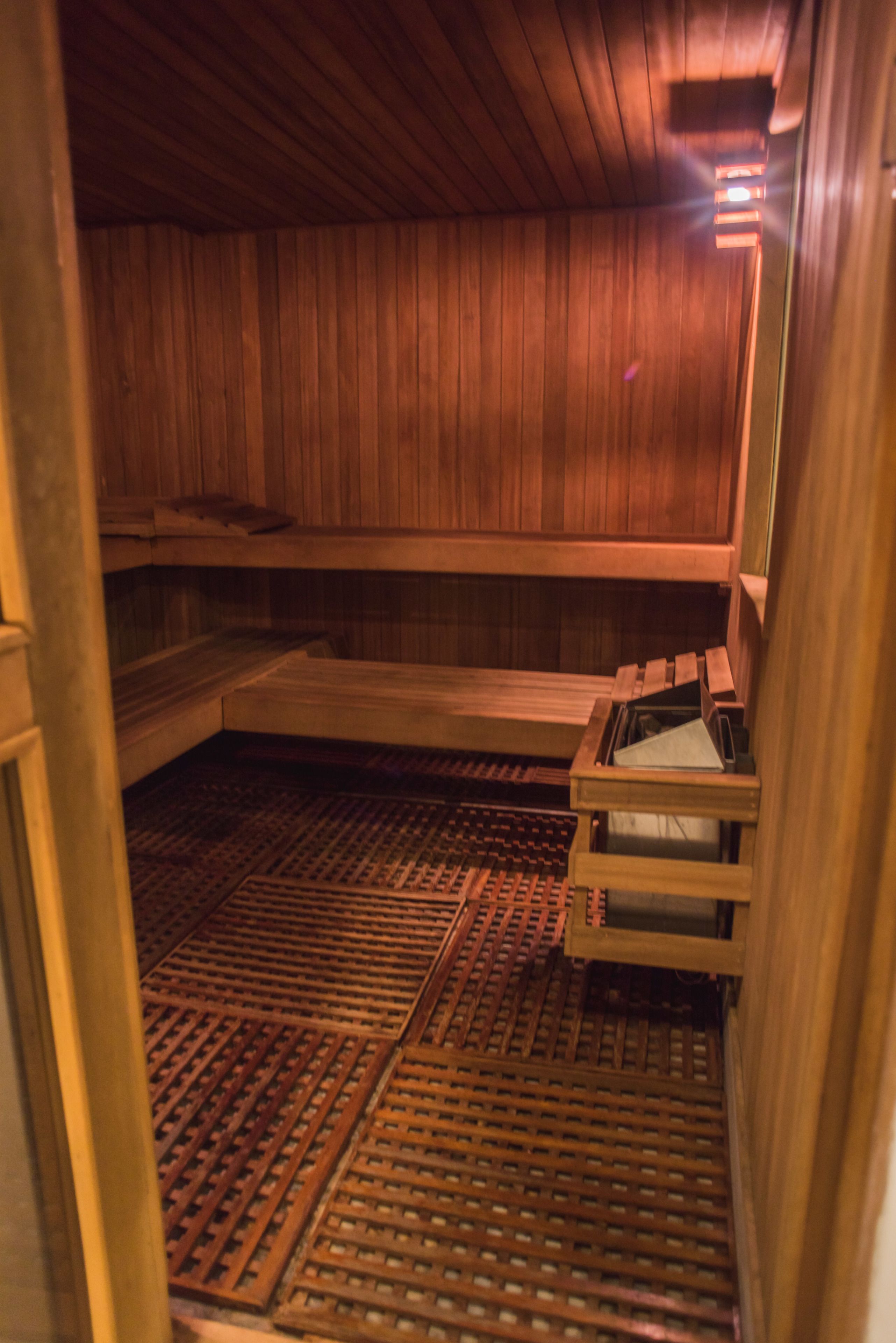 A sauna with wooden walls and benches.