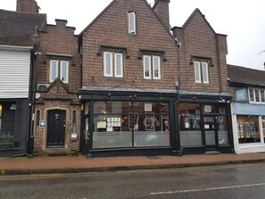 A traditional brick building with a black awning, a sign for 'HUMBERS' to the right, and a visible entrance.