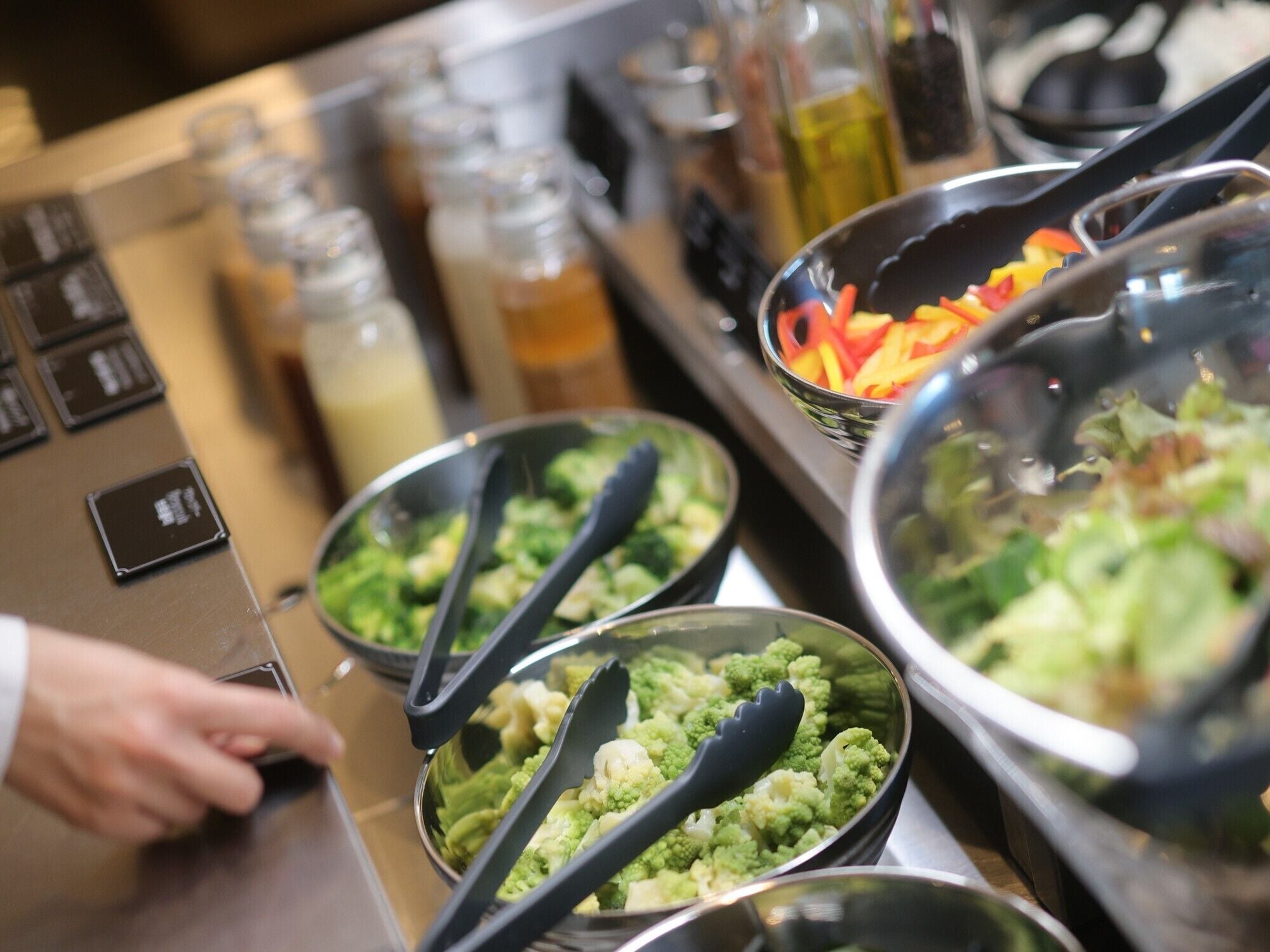 A buffet setup with various food items and utensils.
