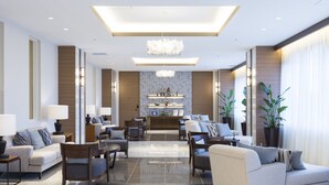 Un moderno vestíbulo de hotel con una zona de estar central, una recepción y una pared decorativa.