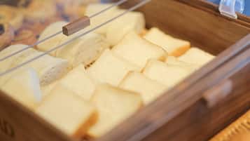 A wooden bread display case with multiple slices of bread.
