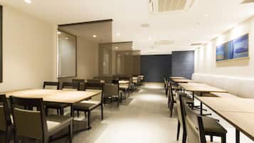 Meetings take place in this spacious conference room with a long table and comfortable seating for all.