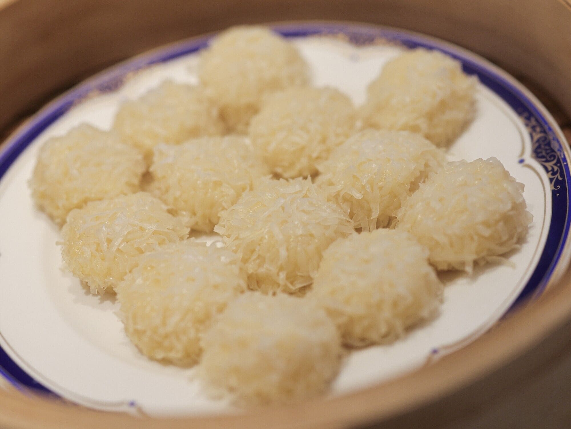 A bowl of food with a white and blue rim.