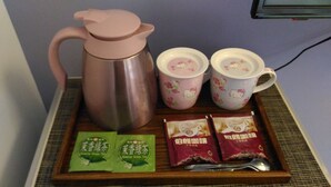 A tray with a pink teapot, two Hello Kitty cups, and four tea packets. - The Awesome Manor (Ji'an)