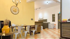 A dining area with a checkered floor, a clock, and a chandelier. - The Awesome Manor (Ji'an)