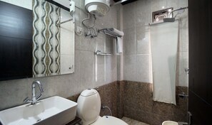 A modern bathroom with a sink, toilet, and shower.