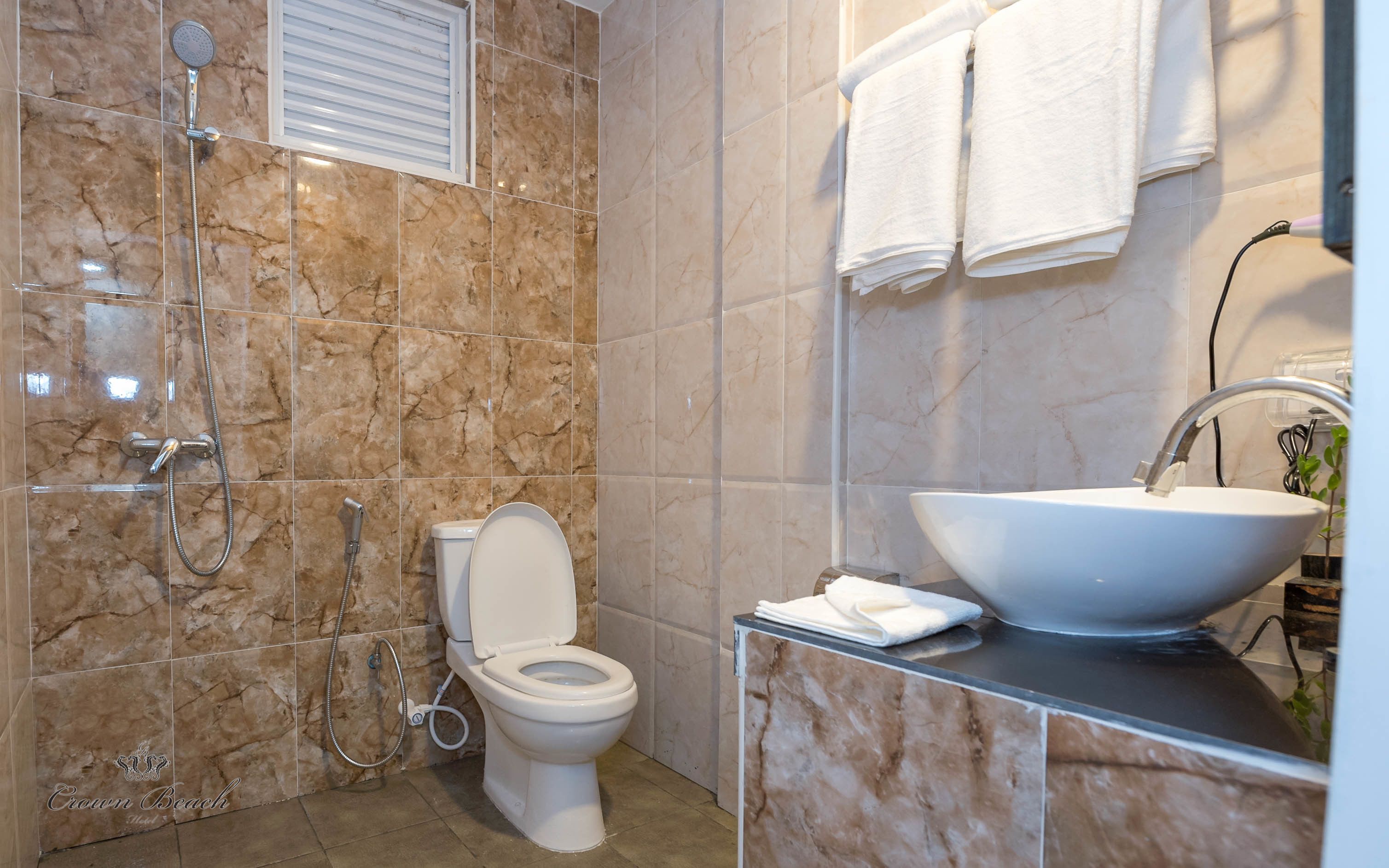 shower, designer toiletries, hair dryer, towels