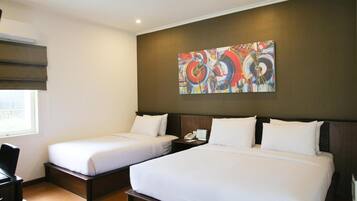 A hotel room with two single beds, a large abstract painting on the wall, and a window with blinds.