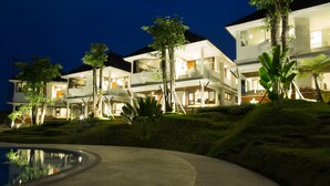 A modern resort with multiple two-story buildings, a swimming pool, and tropical landscaping. - Samara Resort (Batu)