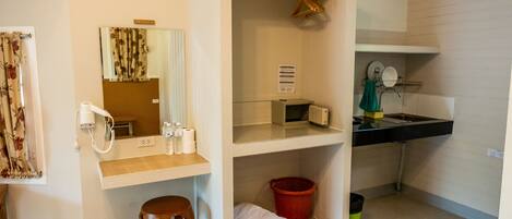 A bathroom with a mirror, towel rack, sink, and a red basket.