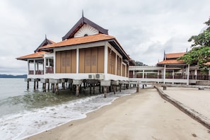 A beachfront building with a traditional design, featuring a covered walkway over the water. - Casuarina@Pangkor (Pangkor Island)