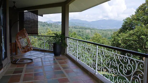 A balcony with a view of a mountainous landscape.