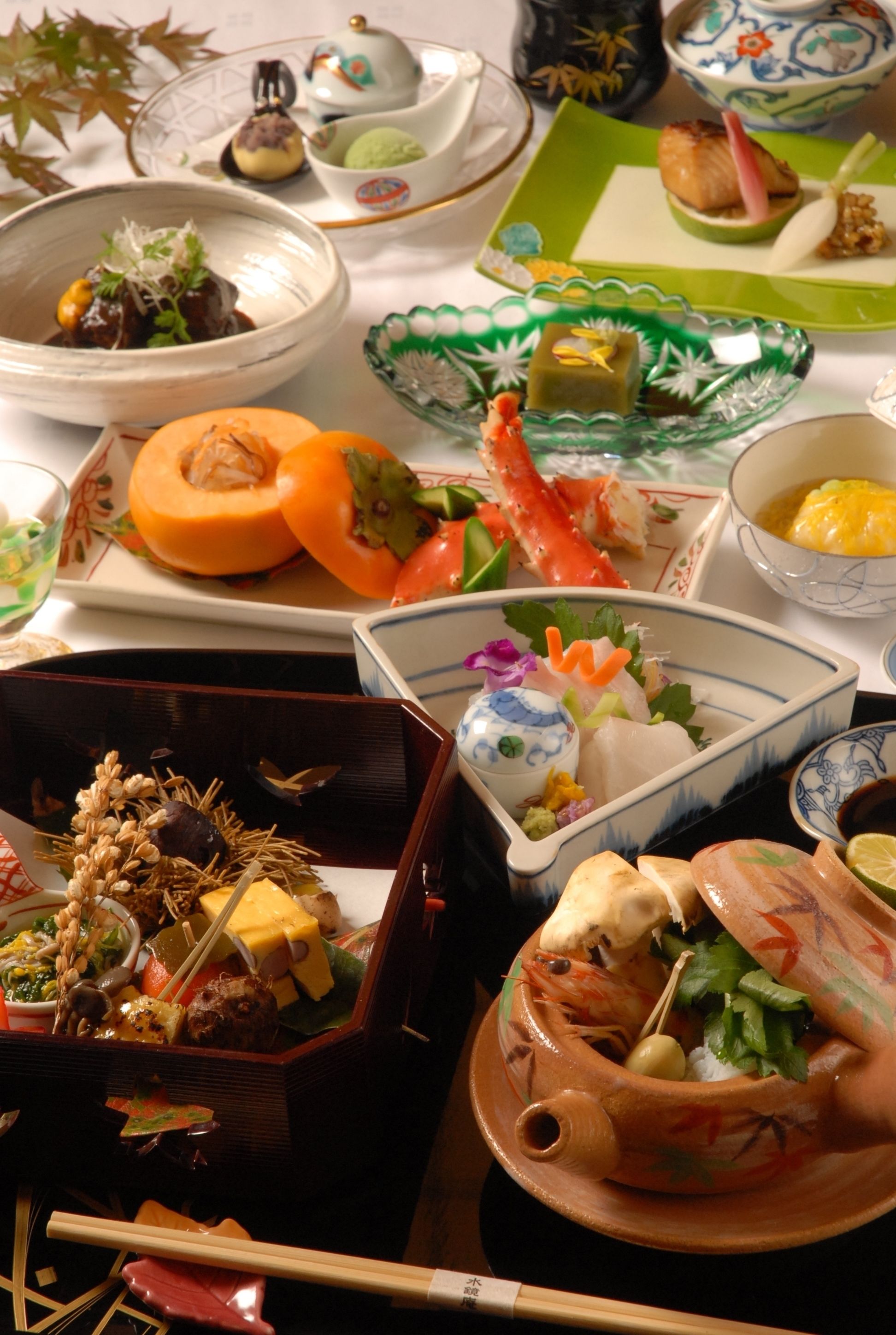 A variety of dishes on a table, including seafood, vegetables, and a bowl of soup.