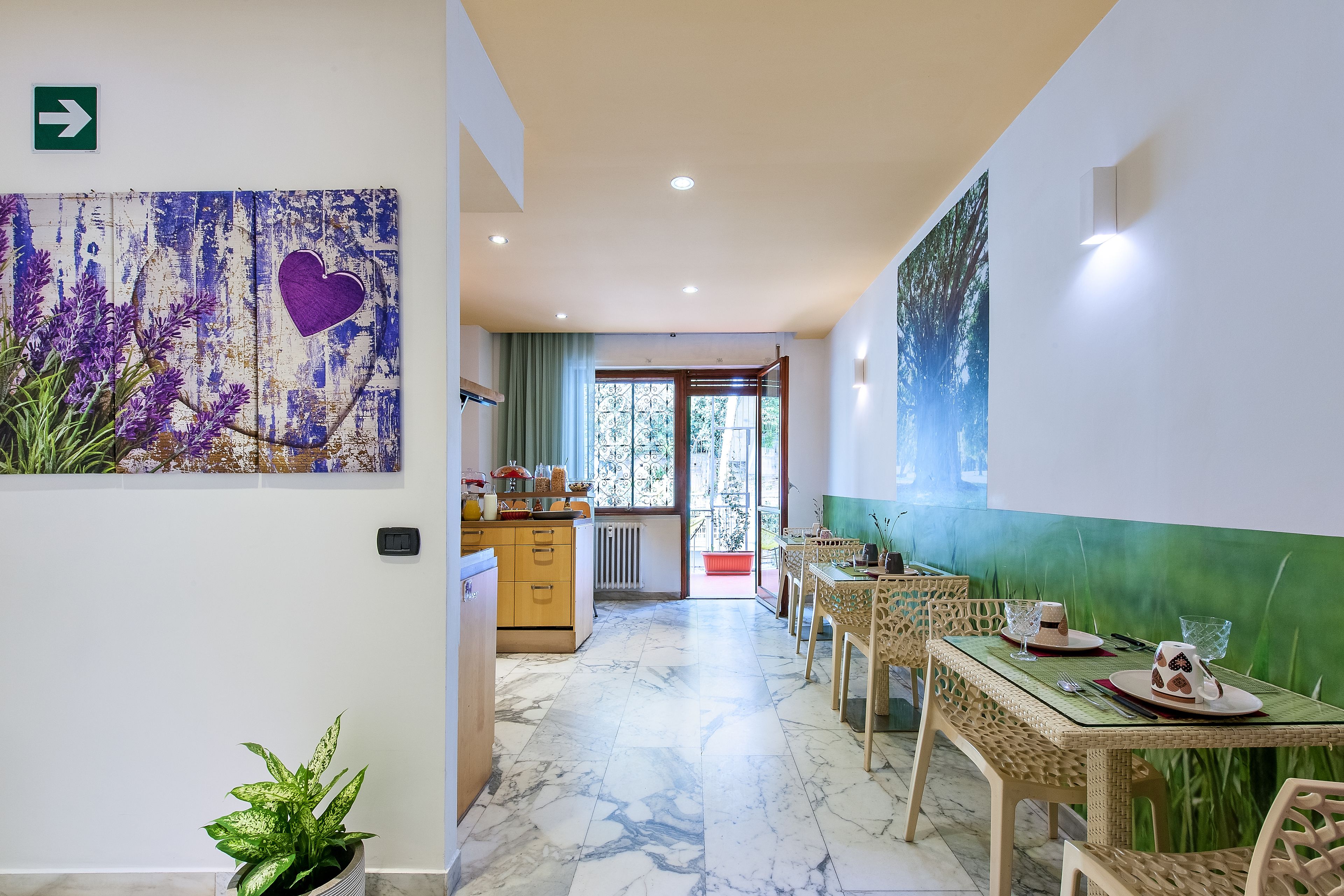 A hotel dining area with a marble floor, wooden furniture, and a view of the outdoors.