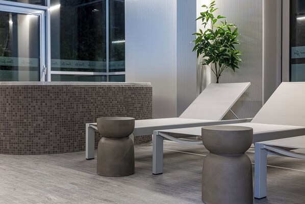 A modern waiting area with two lounge chairs, a small table, and a potted plant. - Grand Baltic Dunes (Palanga)