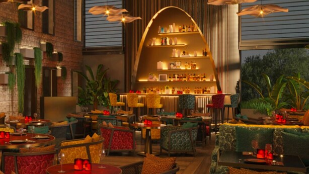 A restaurant with a central bar area, multiple seating options, and hanging pendant lights. - The View Rabat (Rabat)
