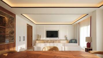 Une chambre d’hôtel moderne avec une table à manger en bois, un canapé et un téléviseur fixé au mur.