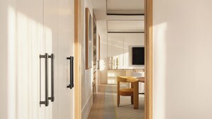 A modern interior with a wooden floor, a dining area with a table and chairs, and a TV mounted on the wall. - The View Rabat (Rabat)