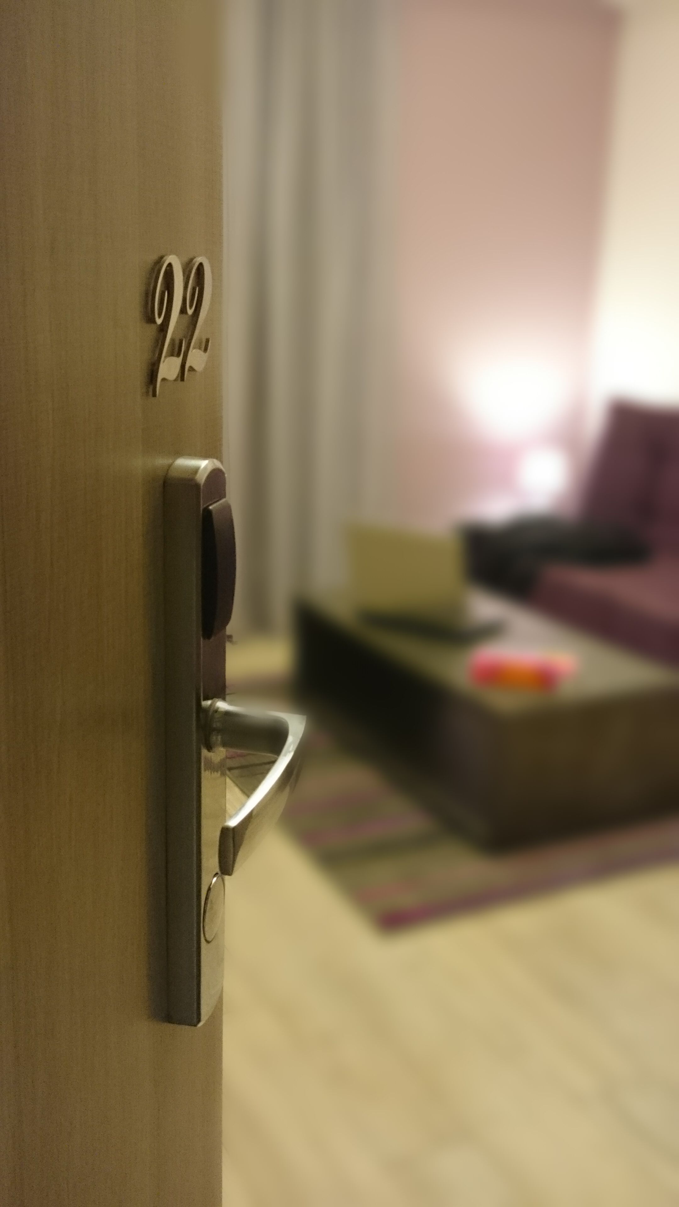 A close-up of a door with a numeric keypad and a keyhole.