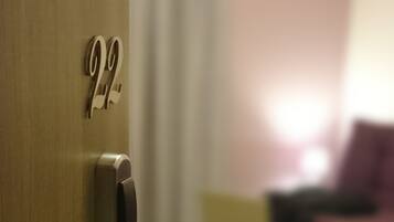 A close-up of a door with a numeric keypad and a keyhole.