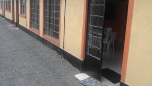 A building with multiple windows and doors, some with metal bars. - Sleepway Cottages (Nakuru)