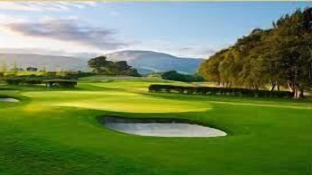 A golf course with bunkers, a water hazard, and a forested area. - Sleepway Cottages (Nakuru)