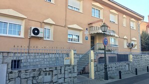 Un hôtel avec une façade en pierre, de nombreuses fenêtres et une enseigne indiquant qu’il s’agit d’un hôtel.