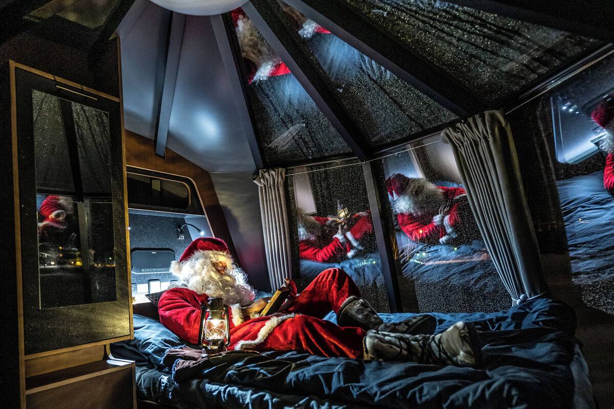 A cozy room with a bed, a window, and a ceiling light.