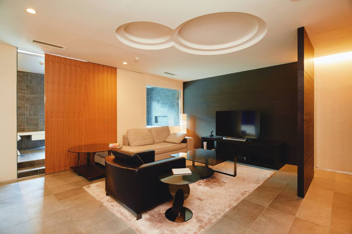A modern living room with a sofa, coffee table, and TV.