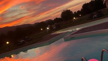 Seasonal outdoor pool, open 8:30 AM to 8:30 PM, pool umbrellas