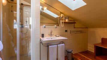 Une salle de bain moderne avec une douche à parois de verre, un lavabo blanc et un meuble-lavabo en bois.