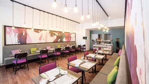 A modern restaurant with a long counter, multiple tables, and a seating area with cushioned benches. - Hotel Montana (Geneva)