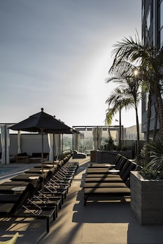 Outdoor pool, cabanas (surcharge), pool umbrellas at Kimpton Everly Hotel Hollywood by IHG