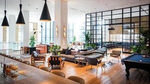 A spacious lounge area with a pool table, sofas, and a dining area. - Kimpton Everly Hotel Hollywood by IHG (Los Angeles)