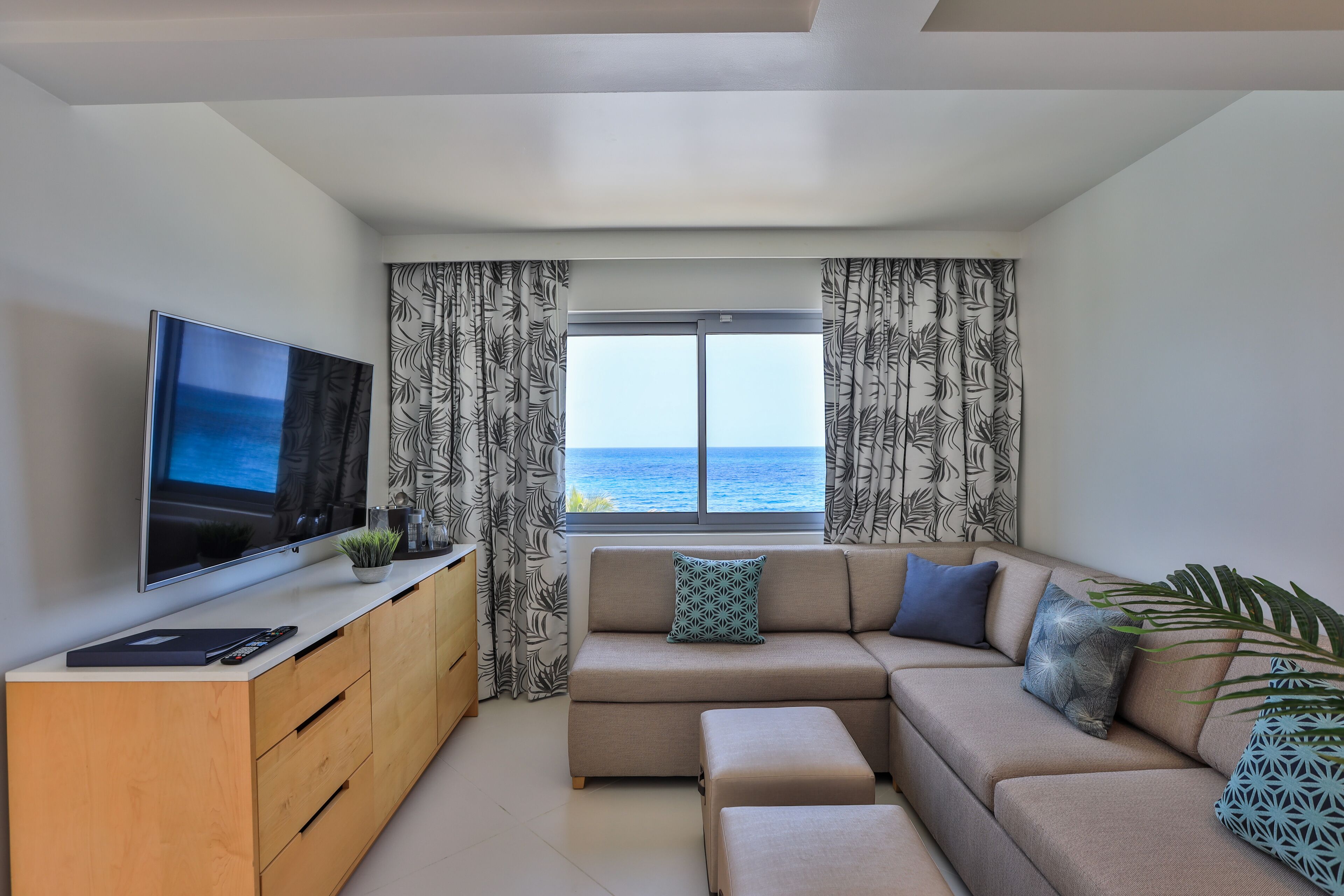 junior oceanfront suite | living area | 55-inch smart tv with satellite channels, tv, netflix