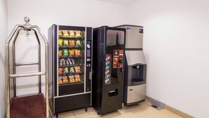 A vending machine with snacks, a water dispenser, and a return cart. - Econo Lodge Baton Rouge University Area (Baton Rouge)