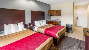 A hotel room with two beds, a small kitchenette, a microwave, and a refrigerator. - Econo Lodge Baton Rouge University Area (Baton Rouge)