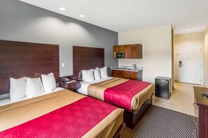 A hotel room with two beds, a small kitchenette, a microwave, and a refrigerator. - Econo Lodge Baton Rouge University Area (Baton Rouge)