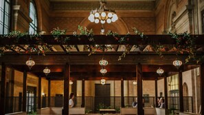 An indoor venue with a wooden ceiling and hanging floral arrangements. - Grand Central Serviced Apartments (Auckland)