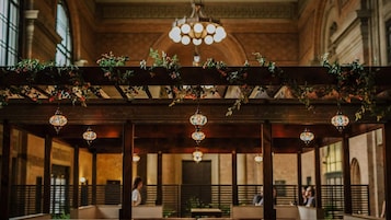 An indoor venue with a wooden ceiling and hanging floral arrangements.