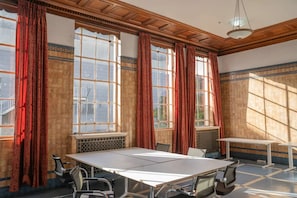 A conference room with a large table, chairs, and large windows with curtains. - Grand Central Hotel Auckland (Auckland)