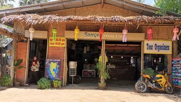 A travel agency named 'Samit' with a signboard indicating it is open from 08:00 am to 09:00 pm.